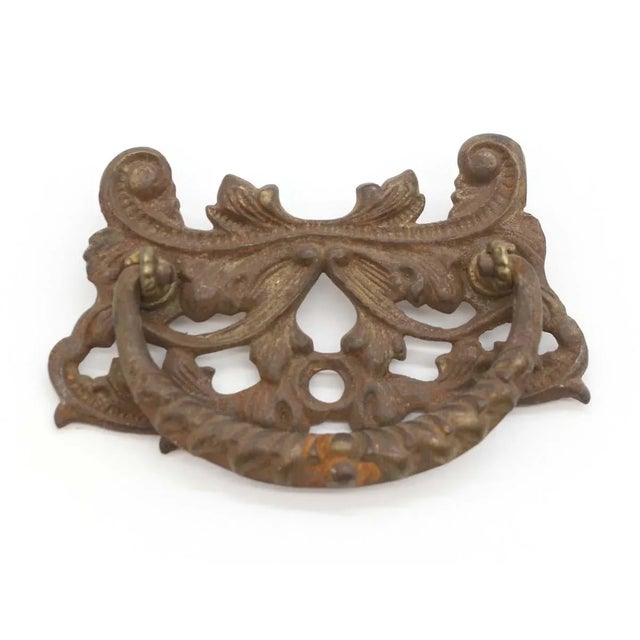 Victorian style dresser drawer pull made of cast iron with an antique brass finish. Mounting screws will be provided. Good...
