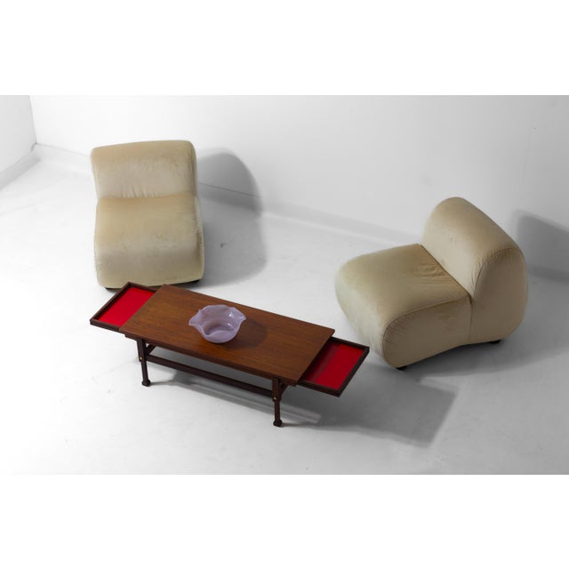 This Italian coffee table has a clean rectangular top supported by a simple frame with slightly tapered legs. On both...