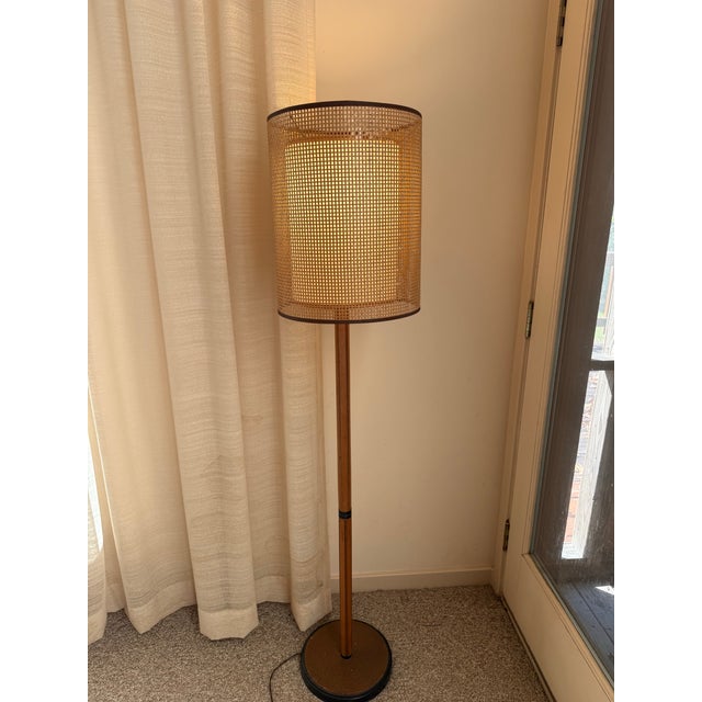 Elegant vintage Mid-Century Modern floor lamp 60” tall featuring a slender warm wood-tone column, circular weighted base...