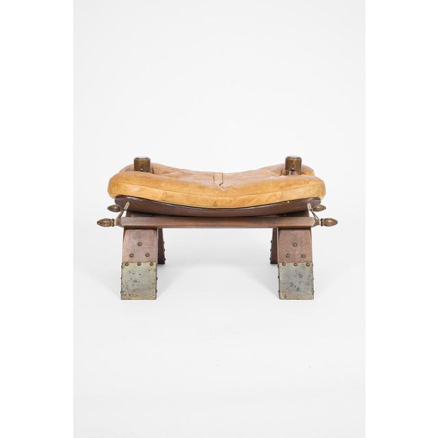 Distinctive vintage footstool inspired by traditional pommel horse equipment, featuring aged leather upholstery, solid...