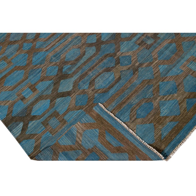 Beautiful modern flat-weave Kilim handmade wool rug with a blue field. This Kilim rug has accents of brown in a gorgeous...