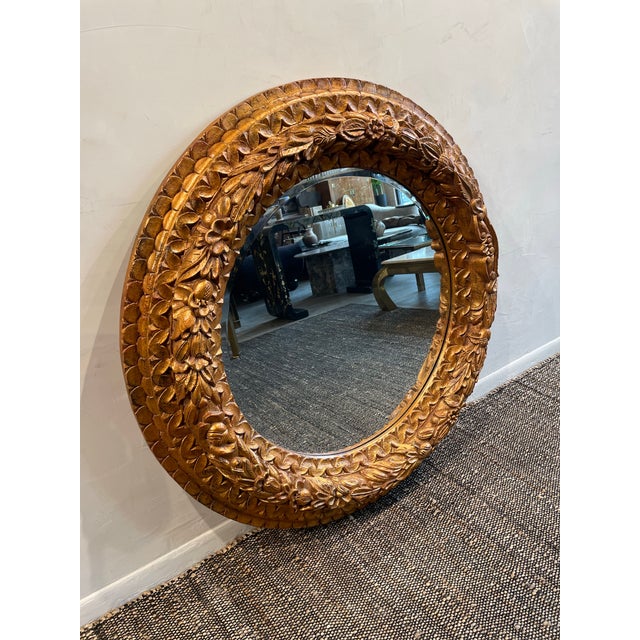 Make a statement with this stunning vintage round mirror, featuring an intricately hand-carved wood frame adorned with...