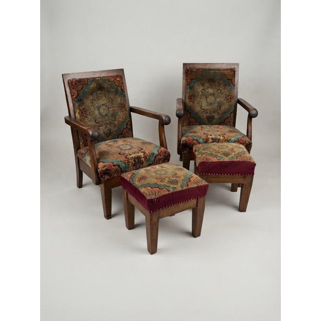 A magnificent pair of Hungarian Art Deco lounge armchairs complete with their matching ottomans, featuring rich wood...