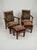 A magnificent pair of Hungarian Art Deco lounge armchairs complete with their matching ottomans, featuring rich wood...
