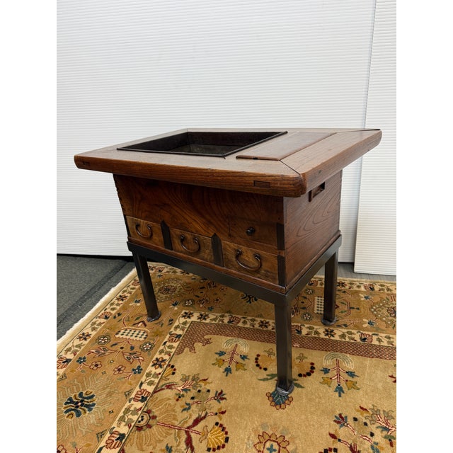 Design Plus Gallery presents an Early 20th Century Japanese Hibachi. Made of elm, unit was originally made for storing tea...