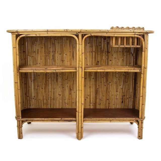 Vintage bamboo and rattan bar, topped with original white formica and adorned with red lacquered fleurette designs on the...