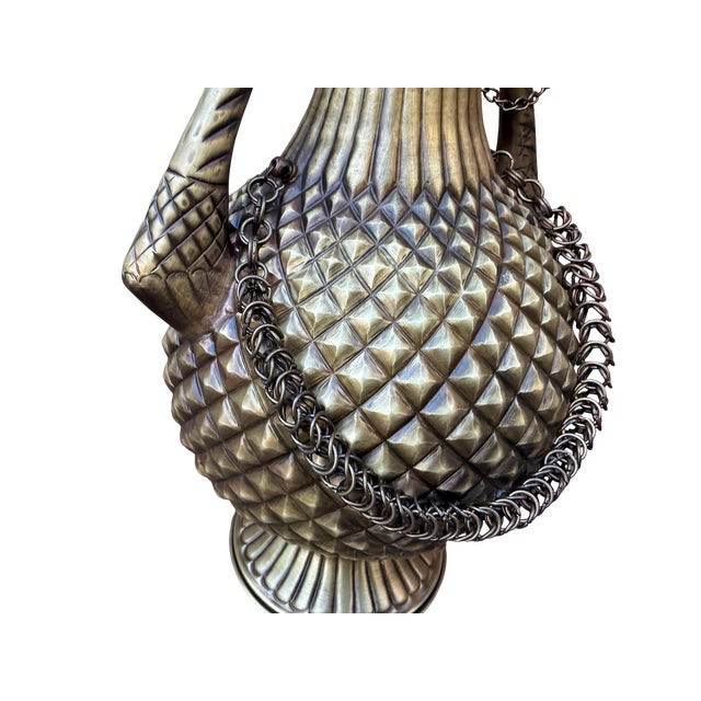 Rising with a disciplined, geometric topography, the surface of this solid brass vessel represents a masterclass in...