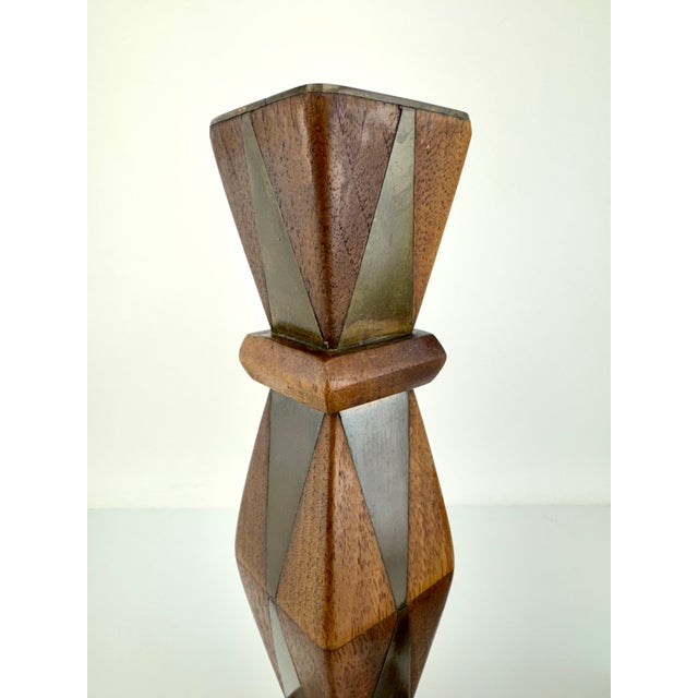 A striking pair of mid-century candlesticks showcasing a bold geometric silhouette with faceted wood construction and...