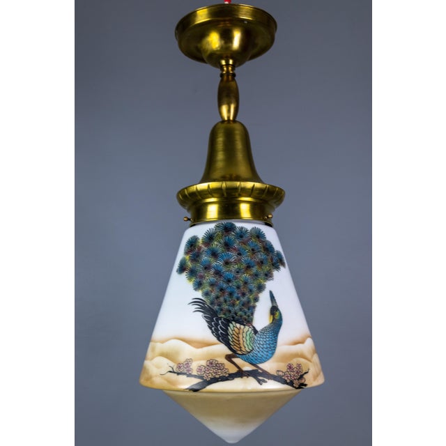 An art deco glass and brass pendant light with bird paintings, france, 1930s. this delightful ceiling light features a...