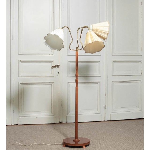 A 1950s floor lamp manufactured by Orsjö, Sweden, model 236. This elegant Scandinavian piece features a turned beechwood...