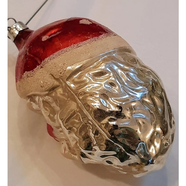Step into a world of vintage charm with this exquisite West Germany Mercury Glass Old St Nick Christmas Ornament! Dating...