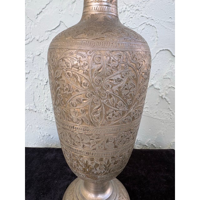 This vintage hand-engraved brass vase features intricate all-over floral and foliate motifs arranged in horizontal bands,...