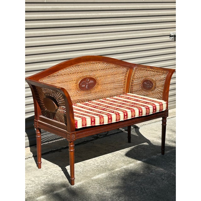 Carved hardwood frame,typically mahogany or walnut, featuring fluted legs and continuous rolled arms Comes with cushion