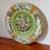 Midcentury Italian Capodimonte plate with hand-painted relief of cherubs, ladies, and swans in a garden, accented with...