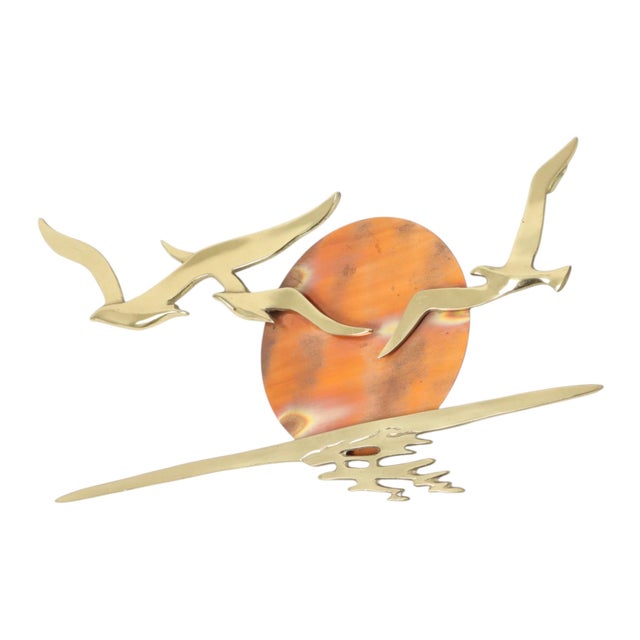 Beautiful vintage wall ornament—a sculpture of brass seagulls in flight, set against a red copper sun. Features two-point...