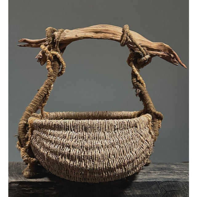 Surrealist Buttocks Basket with Driftwood and Yarn Handle Date: Mid to late 20th century Materials: Natural reed,...