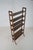 Danish freestanding wooden wall rack from the 1960s. This rack with brass accents has 6 height-adjustable shelves. The...