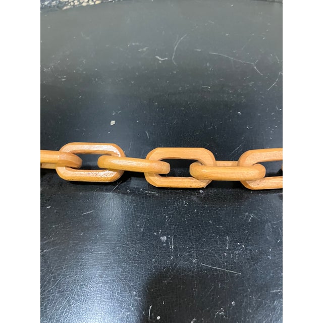 This 56-inch long chain is composed of interlocking wooden links, each carved from a single piece of wood. The continuous...