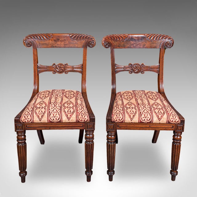 This is a pair of hall chairs. An English, fine mahogany morning room or reception seat, dating to the William IV period,...