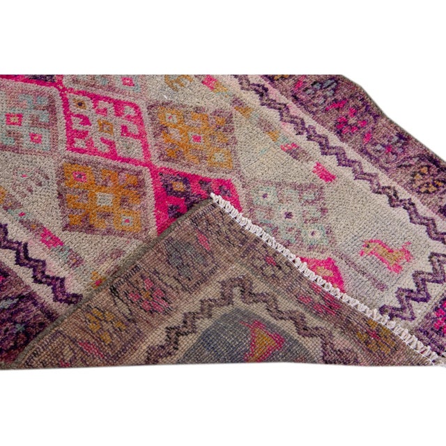 Beautiful Turkish Geometric hand-knotted wool rug with a multicolor field. This rug has pink accents all-over a geometric...