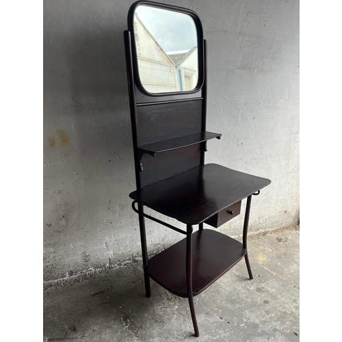 Introduction elegant antique wooden washstand or vanity table from the early 20th century, featuring a softly curved...