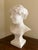 A beautifully carved Carrara marble bust of a young woman, created in France during the 1920s and signed by sculptor Paul...
