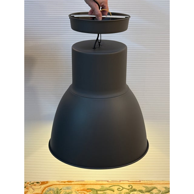 Design Plus Gallery presents a Hektar Dark Gray Pendant Lamp by Ikea. The simple, oversized metal shape is inspired by old...
