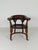 A fine 19th-century English Victorian saddle-seat desk chair, crafted from solid mahogany, dating to circa 1880. The chair...