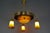A beautiful four-light Art Nouveau brass pendant chandelier with Pâte de Verre glass by Noverdy. This impressive French...