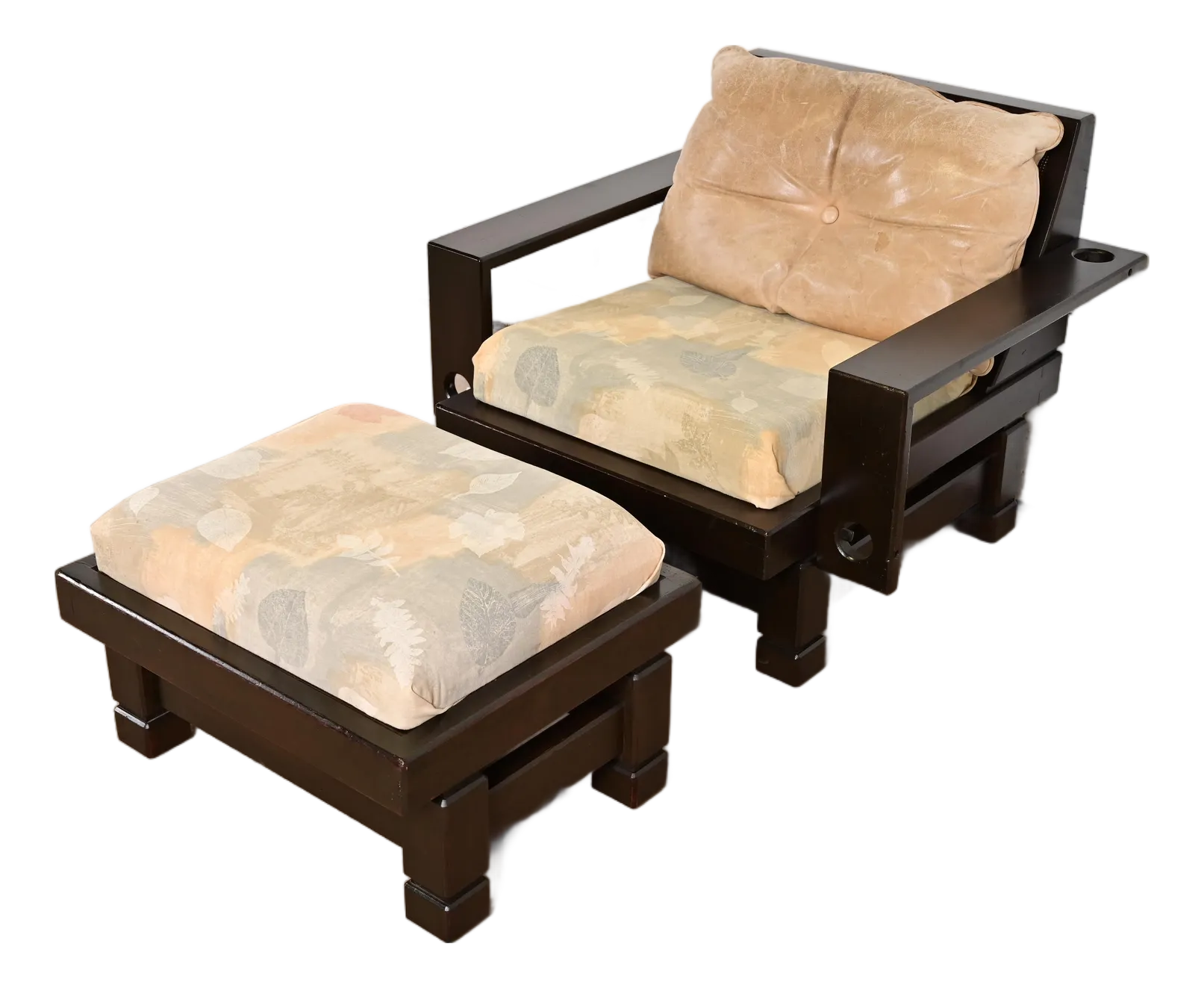 Dark brown lounge chair and ottoman with tan cushions.