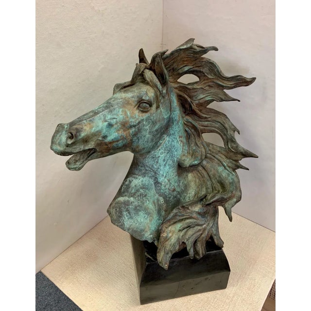 An energetic original bronze sculpture of a mustang bust on a stand. The lifelike piece is styled after the 'Mustangs of...