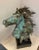An energetic original bronze sculpture of a mustang bust on a stand. The lifelike piece is styled after the 'Mustangs of...