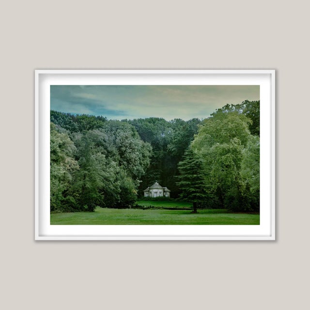 Through a distorted vintage window, a view unfolds. It is morning at the end of summer - the full green foliage of a...