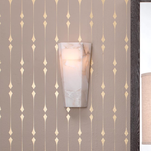 The alabaster Borealis Wall Sconce has the cool luminosity of an Arctic evening. With its organic cut pieces, this hand-...