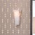 The alabaster Borealis Wall Sconce has the cool luminosity of an Arctic evening. With its organic cut pieces, this hand-...