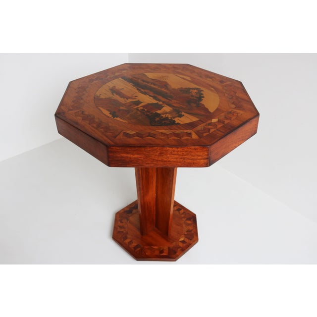Marvelous French Art Deco octagonal table with superb Inlay 1930. This rare Art Deco piece is a stunning display of...