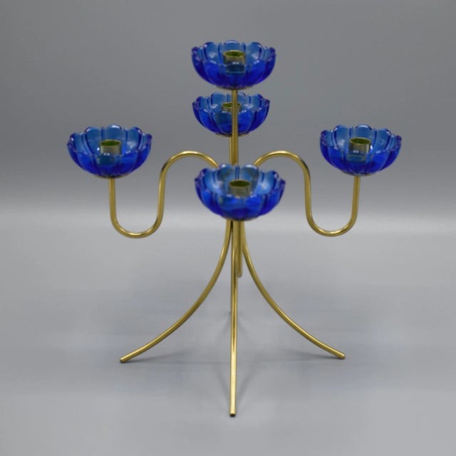 Candleholder in brass and blue glass. This piece has an attribution mark, I am sure that it is completely authentic and...
