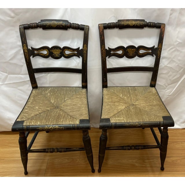 Pair of Sheraton fancy early 19th century Hitchcock chairs with rush seats Scolled center splats with painted decoration...