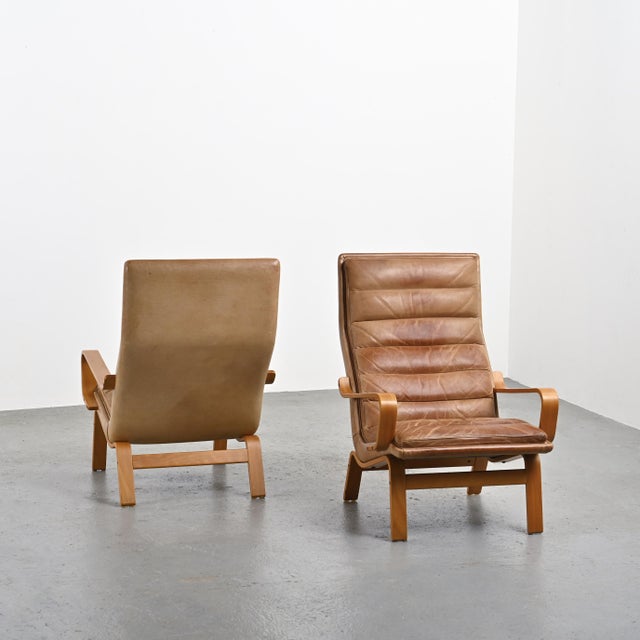 Pair of Contino model armchairs, designed by Swedish designer Yngve Ekström in the 1970s. Made of thermoformed wood, they...