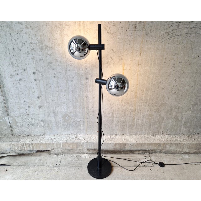 Very rare Temde Lechten floor light with two chrome spheres on a black stained wooden base. The two lights are...