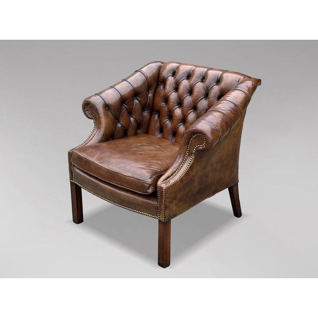 A high-quality, untouched 19th-century brown leather button back club armchair. The substantial, well-shaped frame...