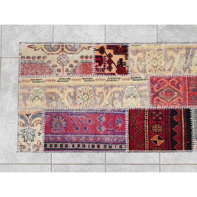 This is a vintage Turkish Oushak rug from the Mid 20th Century. The piece was hand-knotted.