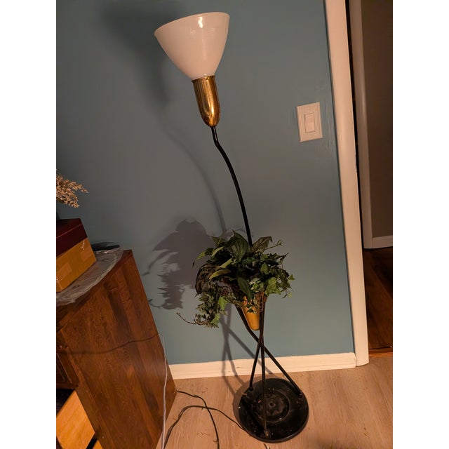 Stunning mid-century floor lamp. iron and brass. surround base at the bottom has a star medallion with surround by iron...