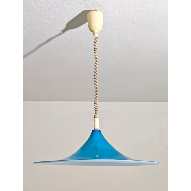 This charming pendant lamp is a magnificent example of Italian Midcentury Modern design, likely dating back to the 1960s....