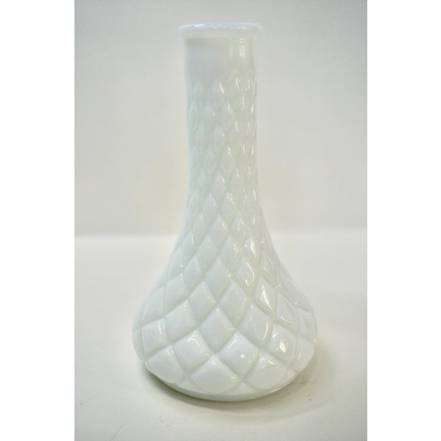 Add a touch of classic mid-century charm to your shelving or tablescape with this curated pair of white milk glass bud...
