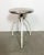 Industrial three-legged medical stool made in former Czechoslovakia during the 1960s. It features a white legs and a...