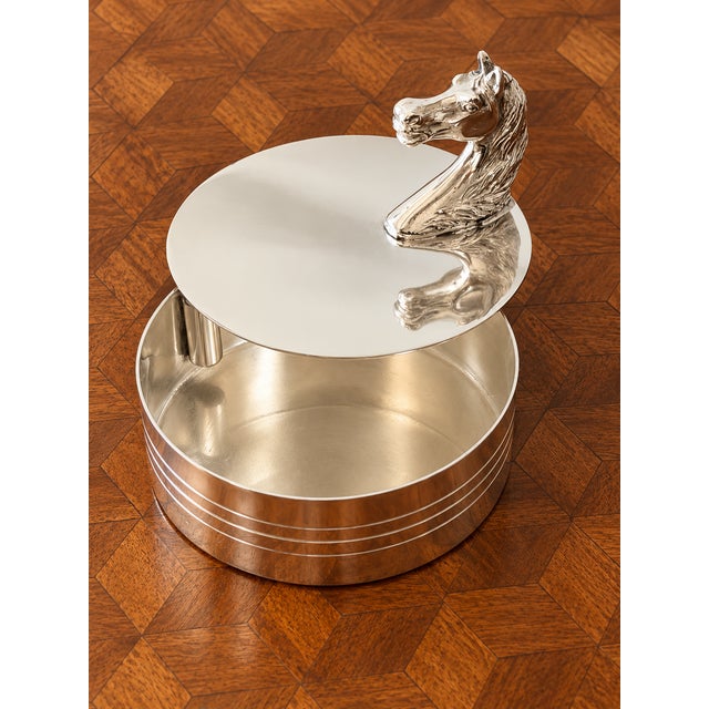 A wonderfully sculptural vintage silver-plated box by Hermès Paris, distinguished by an elegant horse-head handle rising...