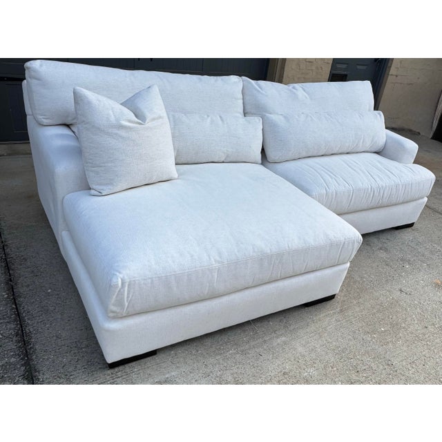 Sectional sofa, upholstered in stain-resistant Performance fabric. Cushions are filled with a down blend and feature...
