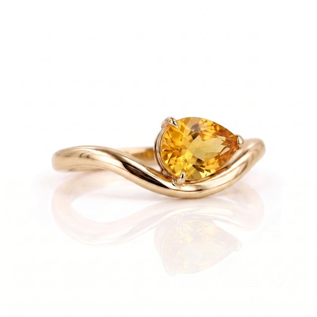 Bring a sparkle of sunshine to your day with this radiant, pear-cut Citrine ring. The sunny, golden-yellow gemstone...