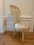 Beige, cane back Louis XVI accent chair with upholstered seat featuring blush roses. This chair has a tall, stately back,...